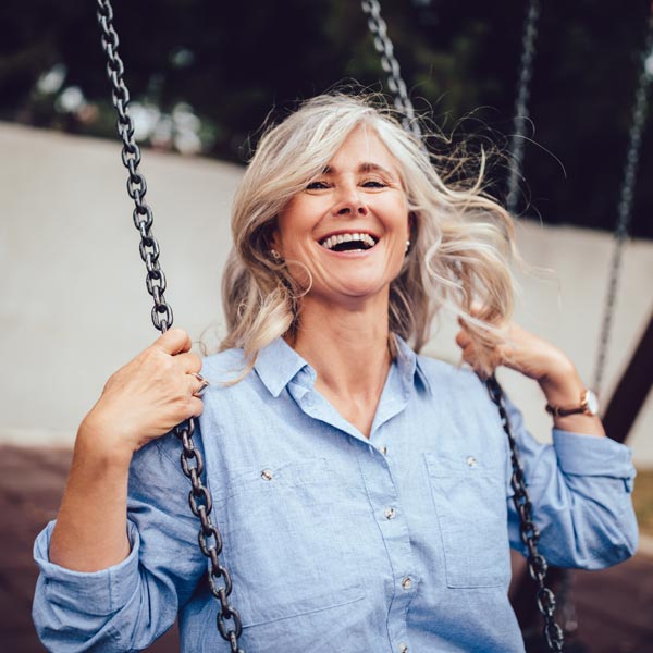 middle aged woman on swing
