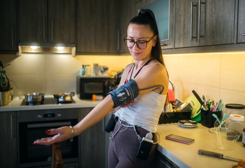 A woman using Holter monitor to record heart electrical activity in Sun City, Glendale, & Peoria, AZ